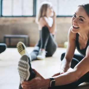 Shot of mature women stretching with a young female instructor during a training class at the gym